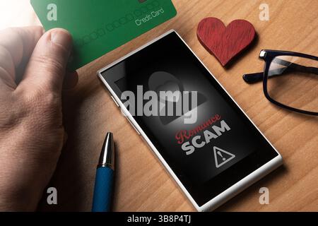 Romance scam concept: man use a credit card to pay for a love scam Stock Photo