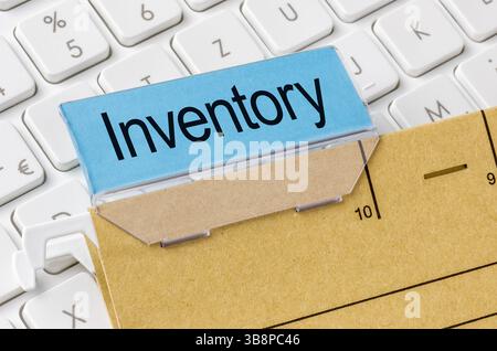 A brown file folder labeled with Inventory Stock Photo