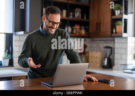 Young business man manager or teacher talking to camera having remote video conference call meeting, virtual hybrid interview, giving online class web Stock Photo