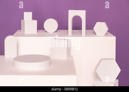 Contemporary Abstract White Geometric Shapes pedestal Set Against a Vibrant Purple Background Stock Photo