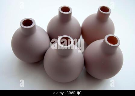 A group of little brown jugs or vases. Clay pots on a white background. Pitchers close-up. Stock Photo