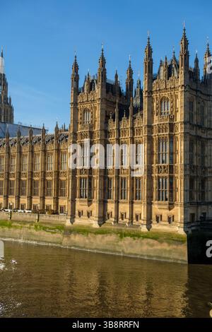 The Palace of Westminster, home to the UK Parliament, stands tall on the River Thames, a symbol of British democracy. Stock Photo
