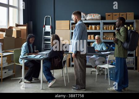 Collaborating in Modern Warehouse Office Environment Stock Photo