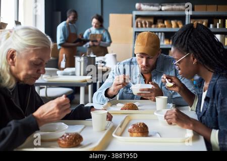 Enjoying Lunch Break in Cafeteria Setting Stock Photo