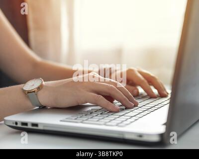 Working from home, contractor, freelance, social media, social marketing concept. Close-up woman's hands typing on laptop keyboard at home. Copy space Stock Photo