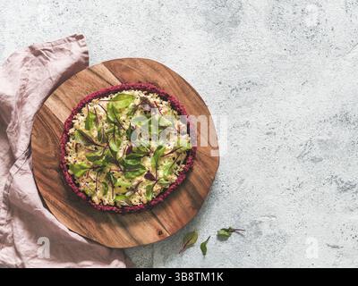 Beetroot pizza crust with fresh swiss chard or mangold beetroot leaves.Ideas and recipes for healthy vegan snack.Egg-free pizza crust with chia seed a Stock Photo