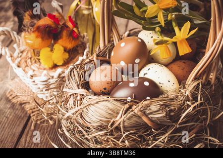 Brown and yellow eggs in basket, Easter decorations Stock Photo