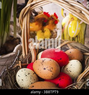 Brown, red and yellow eggs in basket, Easter decor Stock Photo