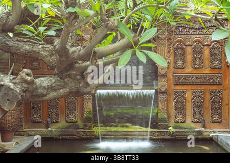 Handmade Waterfall on The Fish Pond behind the Tree Stock Photo