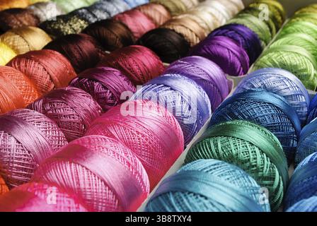 Different color threads on rows in the store Stock Photo