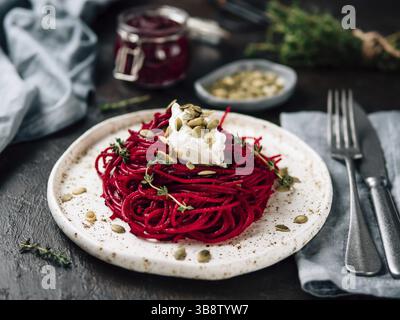 Beetroot pesto or hummus. Homemade beet pesto sauce in glass jar and fresh thyme on dark black background. Copy space for text. Ideas and recipes for Stock Photo