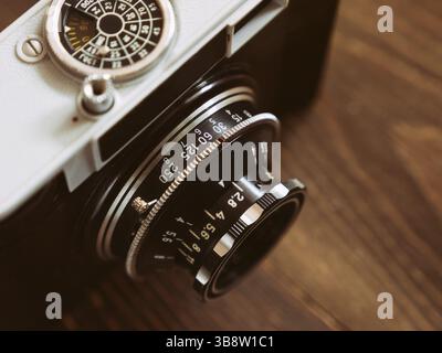 Close up photo of old vintage camera lens over wooden table. selective focus Stock Photo