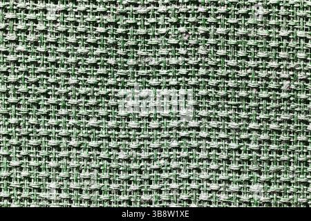 Green and black woven fabric texture background. Closeup of textile surface with detailed pattern. Abstract cloth material for design, fashion. Stock Photo
