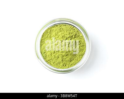 Green matcha tea powder in small glass bowl on white background. Powdered maccha tea, isolated on white with clipping path. Top view or flat lay. Copy Stock Photo