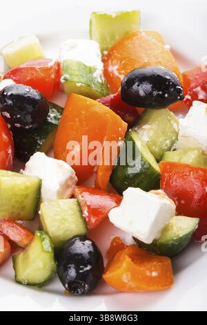 Greek salad with feta cheese macro on white plate Stock Photo