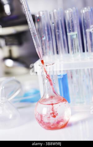 Scientist shows a diffusion in the flask Stock Photo