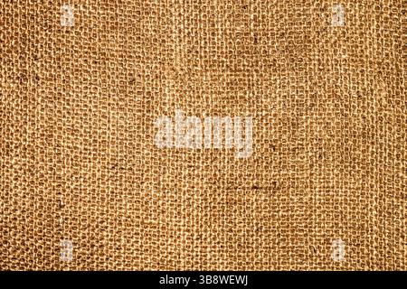 Brown burlap sack texture background. Coarse rustic jute fabric closeup. Natural rough material surface. Vintage woven pattern for crafts or design. Stock Photo