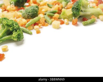 Frozen vegetables assorted isolated on white with clipping path. Frosen vegetables with ice Isolated one edge. Frozen mix vegetables with copy space f Stock Photo