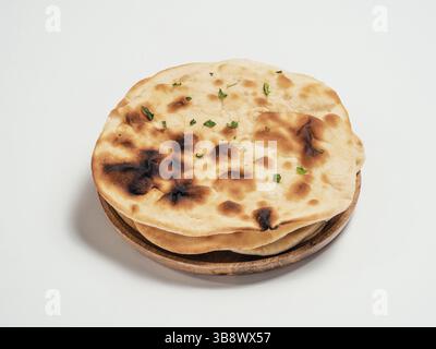 Fresh naan bread on plate isolated on white background. Stack of several perfect naan flatbreads on white Stock Photo