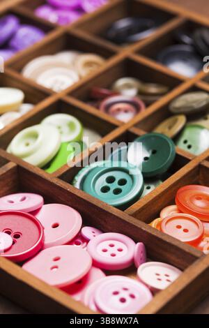 Colorful buttons in a wooden box for design Stock Photo