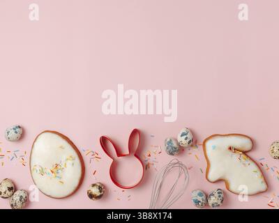 Easter cooking baking concept. Easter cookie cutter on pink pastel background. Happy Easter Day concept. Easter cookie cutters and cookies, colorful e Stock Photo