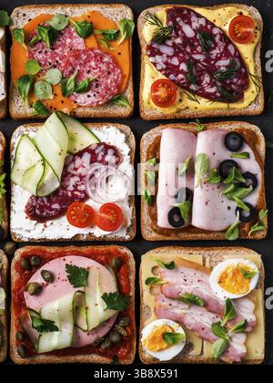 Set of eight different sandwiches with meat in square shape. Top view or flat lay. Assortment meat toasts on black background. Idea, creative concept Stock Photo