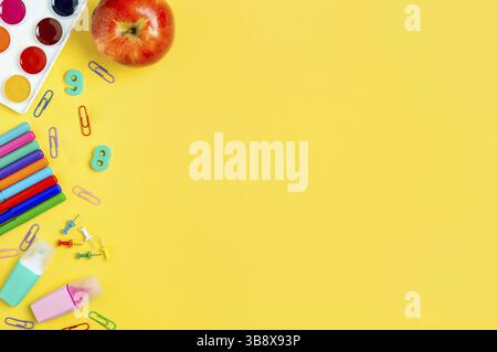 Education, back to school, freelancer painter work concept. School supplies, watercolors, stationery accessories over yellow background. Flat lay, top Stock Photo