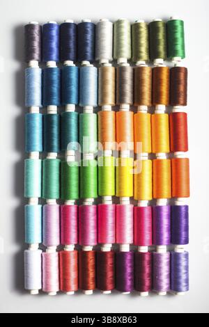 Reels with multi colored sewing threads green background Stock Photo ...