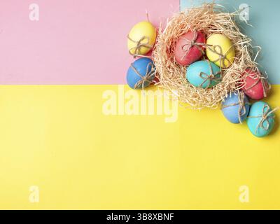 Easter concept. Colorful eggs on bright colorful background with copy space for text. Top down view or flat lay Stock Photo