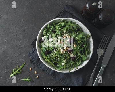 Beetroot, aragula and soft cheese salad over black background. Top view or flat lay. Copy space for text. Idea and recipe for healthy vegetarian salad Stock Photo