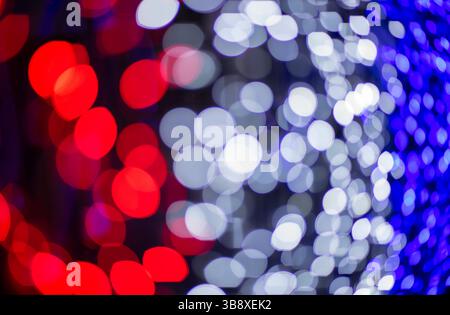 Abstract colorful bokeh orbs on dark background, vibrant defocused light dots pattern, festive overlay texture for photo editing, blurred bright circu Stock Photo