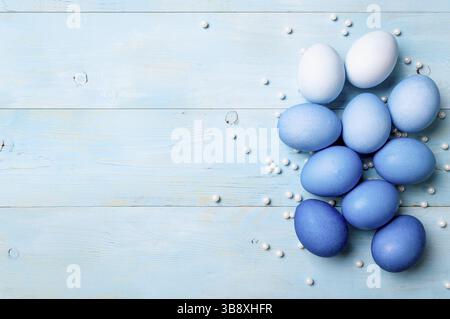 Easter concept. Ombre eggs in blue colors on blue wooden background with copy space for text. Top down view or flat lay. Classic blue colors in Easter Stock Photo