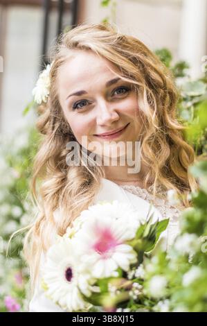 Portrait of a bride in a white dress in the city Stock Photo