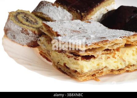 Various cakes on white plate isoleted on white background Stock Photo