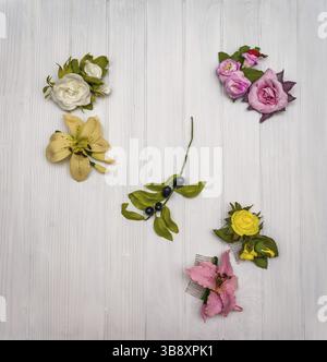 From above different colored artificial flowers on a white wooden board in Ukraine Stock Photo