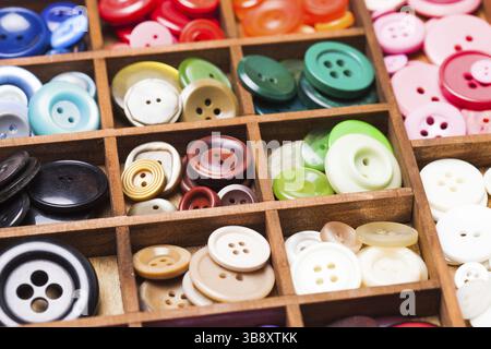 Colorful buttons in a wooden box for design Stock Photo