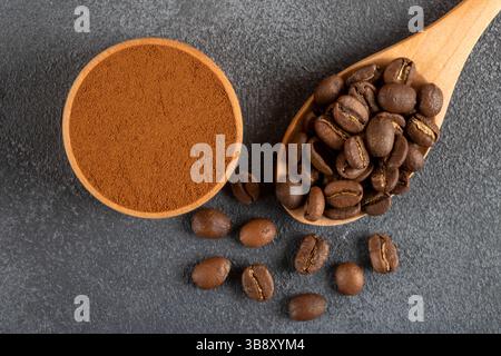 Coffee beans with a bowl of ground coffee on black background Stock Photo