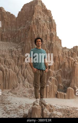 A man exploring and hiking around Cathedral Gorge State Park. A public recreation area and geologic preserve featuring a dramatic landscape of eroded Stock Photo