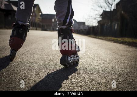 Roller skating on the road, close up legs Stock Photo