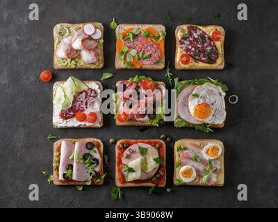 Set of eight different sandwiches with meat in square shape. Top view or flat lay. Assortment meat toasts on black background. Idea, creative concept Stock Photo