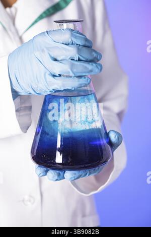 Scientist shows a diffusion in the flask Stock Photo