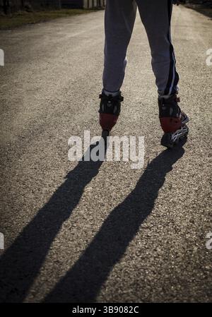 Roller skating on the road, close up legs Stock Photo