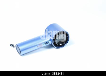 Small plastic Portable fan side view, isolated on white background. Stock Photo