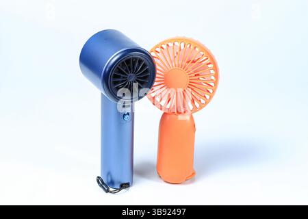 Small plastic Portable fan side view, isolated on white background. Stock Photo