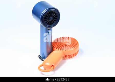 Small plastic Portable fan side view, isolated on white background. Stock Photo