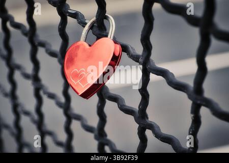 small red heart on the fence Stock Photo