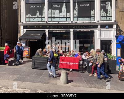 Filling station pub with customers enjoying al fresco food and drink, Royal Mile, Edinburgh Scotland Stock Photo