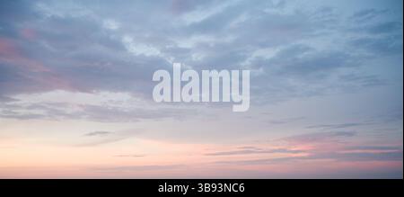 Subtle Sunset Sky: Pastel Clouds. Stock Photo