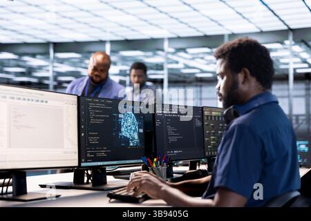 Server farm IT specialist using AI systems to input data faster during complex computational tasks. Software developer in data center using artificial intelligence parallel processing tech Stock Photo
