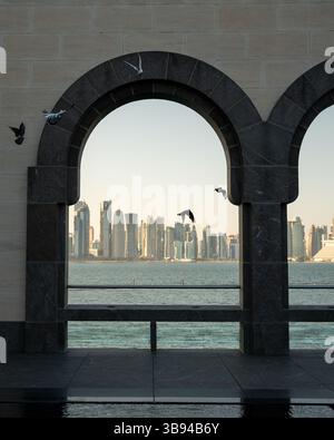 Arches overlooking the city Doha, Qatar. Breathtaking views of the Doha skyline and the Persian Gulf. Stock Photo